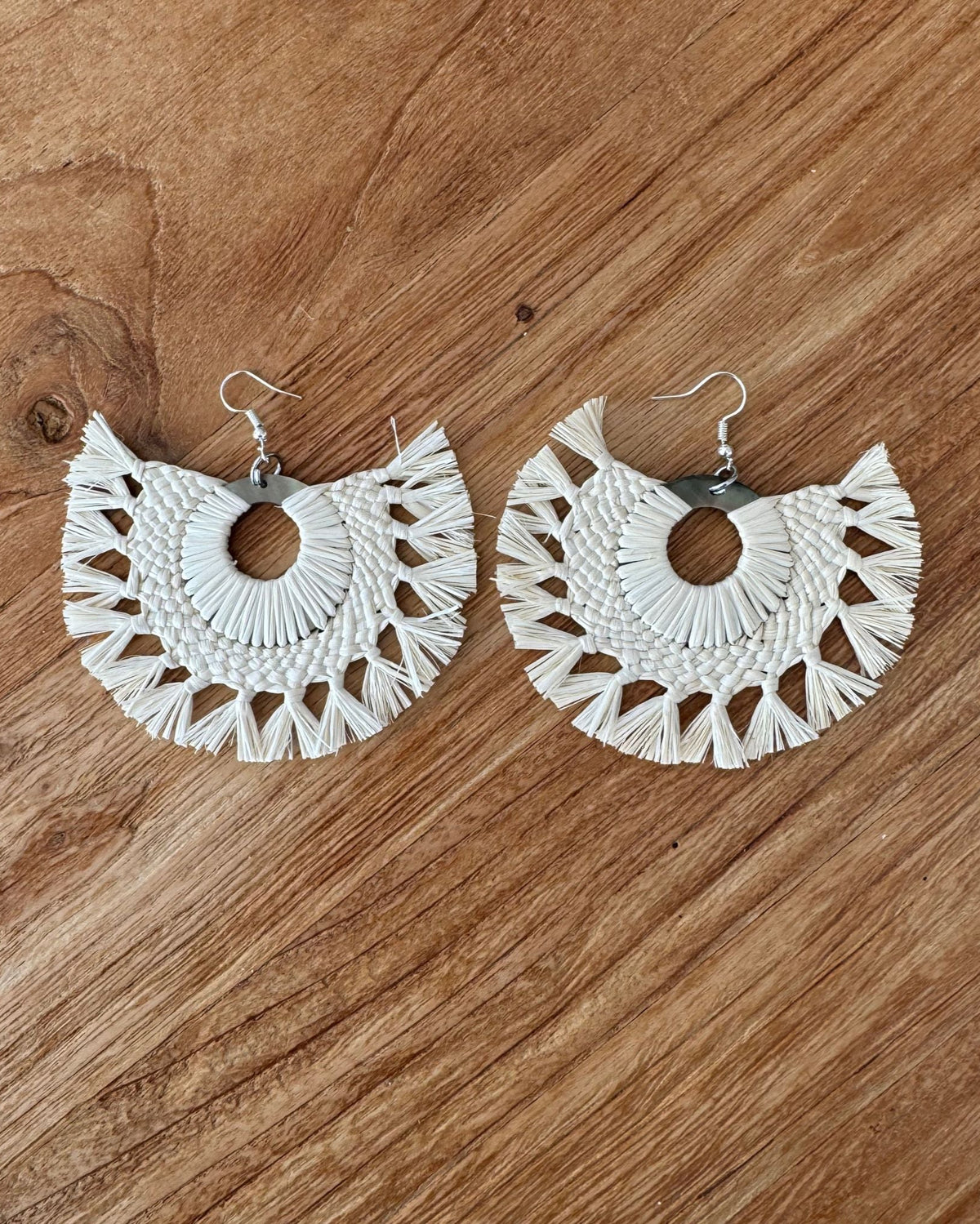 Rito earrings on a wooden surface