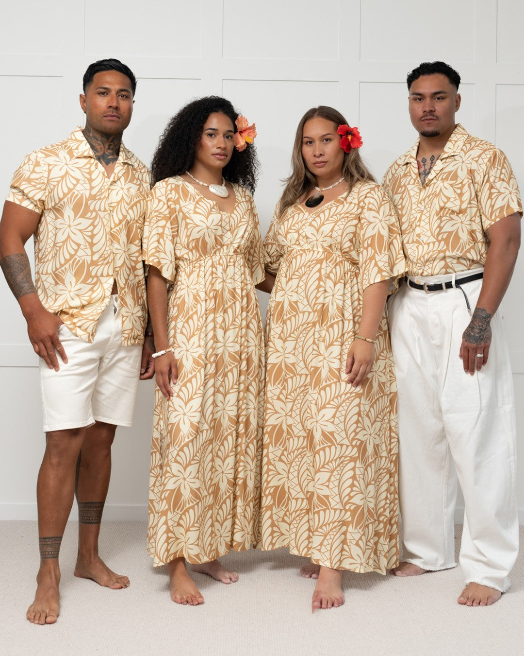 Woman wearing a long, patterned island dress against a white background
