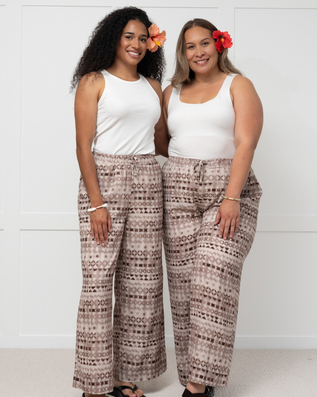 Womens against white wall in pacific motif island fashion pants